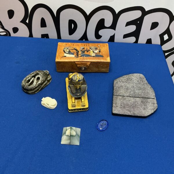 Close-up of Egyptian collectables including a decorative box and scarab beetle.