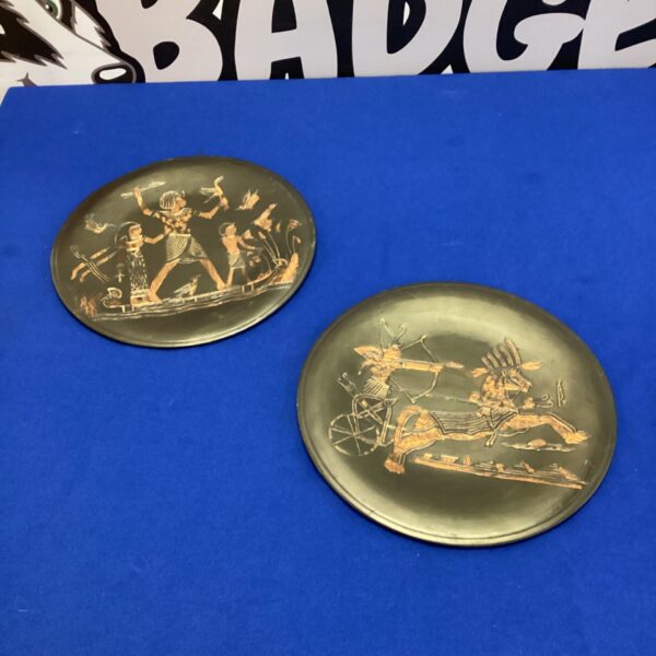 Intricate etching on ancient Egyptian copper plates, detailed relief art.