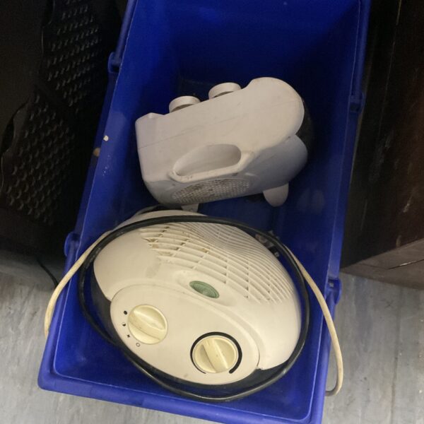 Two electric fan heaters in a blue plastic bin.