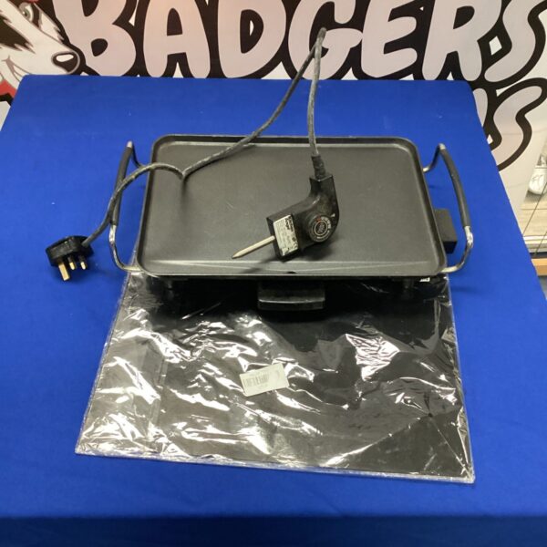 Close-up of electric grill with non-stick surface.