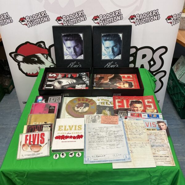 Vintage Elvis Presley ephemera collection with CDs, DVDs, and magazines.