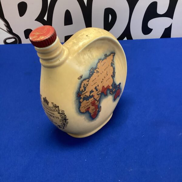 Front view of vintage Emu coronation wine bottle with world map.