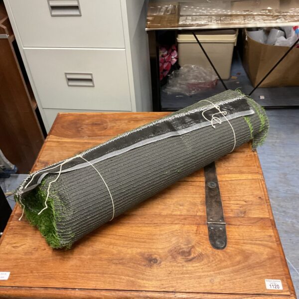 Green roll of artificial grass for garden landscaping.