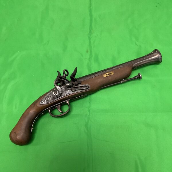 Antique style flintlock pistol replica for wall display.