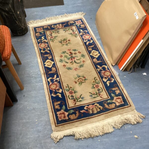 Vintage floral runner rug with repeating pattern.