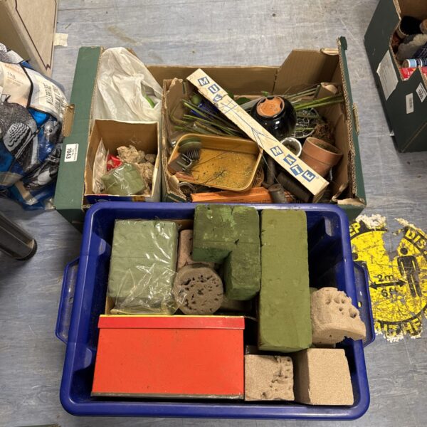 A lot of floral supplies including oasis blocks and plant pots.
