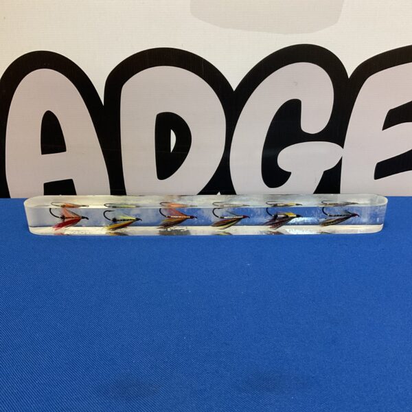 Close-up of fly fishing fly display in a resin block.
