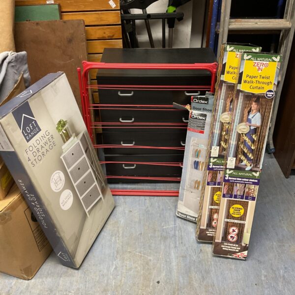 Black folding drawer storage unit with paper twist curtains and shoe rack.