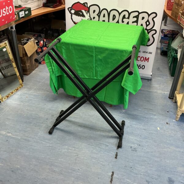 Green padded folding electric organ stand for keyboards.