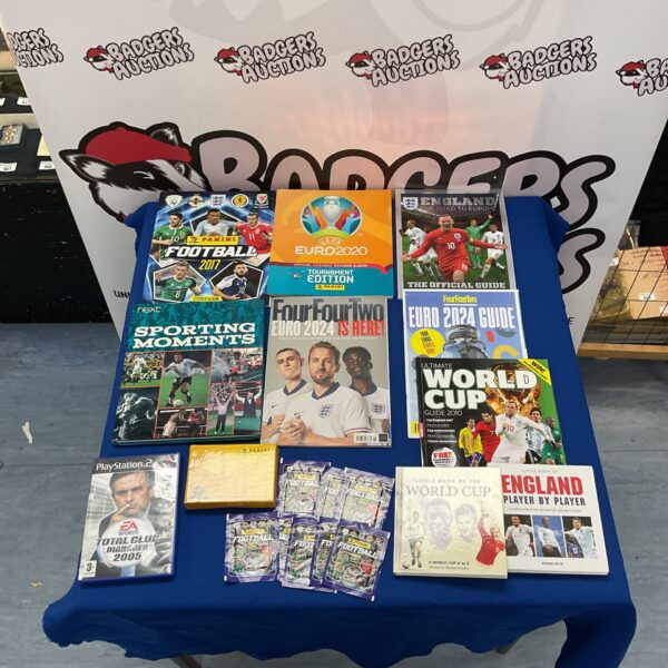 Football memorabilia lot including Panini stickers and magazines.