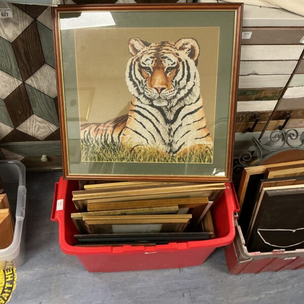 Assorted framed artwork including a tiger print.