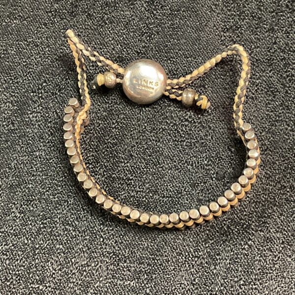 Close-up of a beaded friendship bracelet with silver toggle clasp.