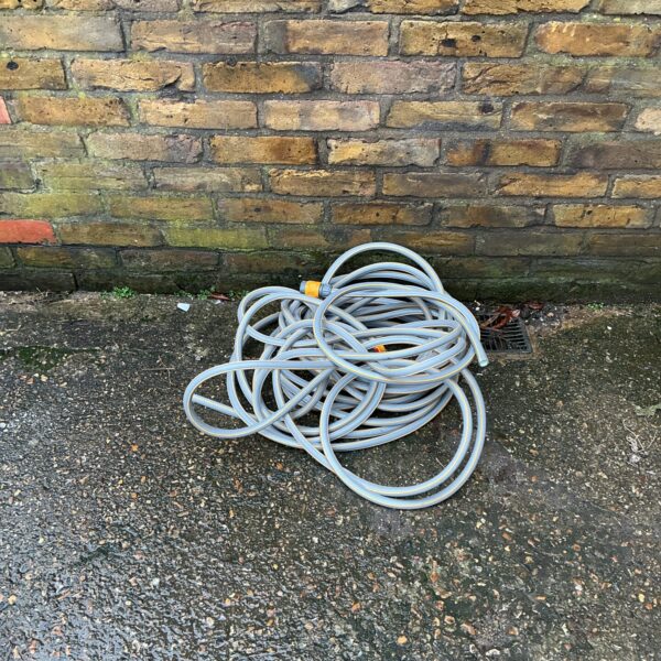 New garden hose coiled and ready for watering.