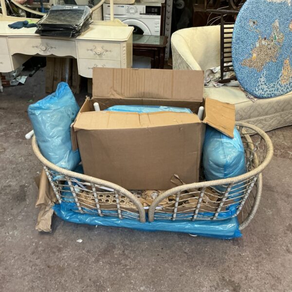 Woven garden patio set with comfortable cushions for outdoor seating.