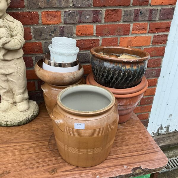 Collection of vintage terracotta and ceramic garden pots for plants.