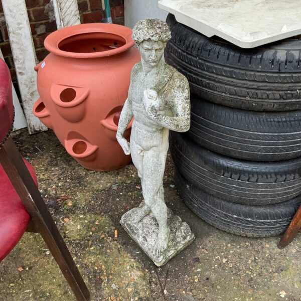 Detailed three-foot tall garden statue in an outdoor setting.