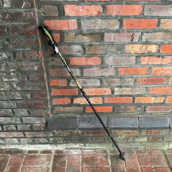 Black and yellow Gelert hiking stick for outdoor adventures.