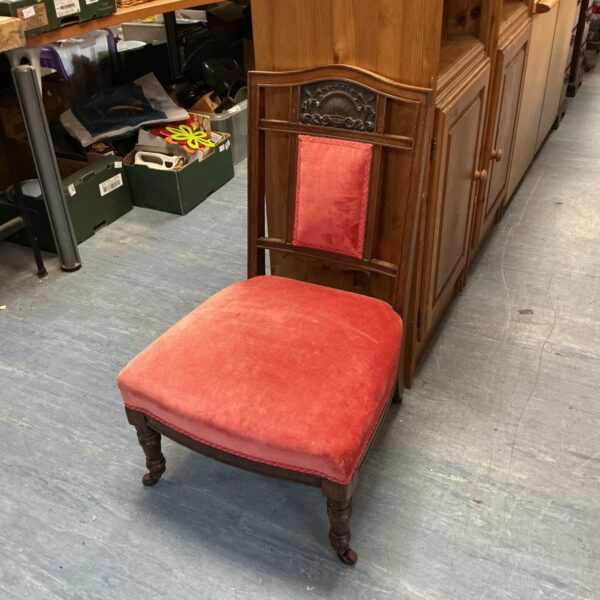 Antique Georgian nursing chair with red upholstery and shell carving.