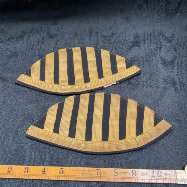German WWI shoulder boards, known as “swallowed nests”, with gold braiding.