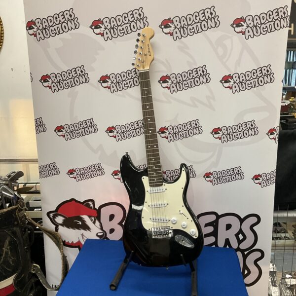 Large black electric guitar for display or collection.