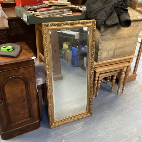 Antique gilt framed mirror with a decorative gold frame.