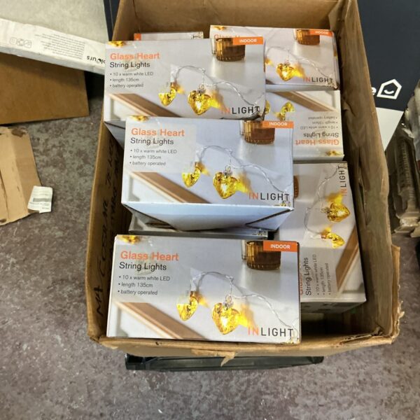 Box of glass heart string lights for indoor decoration.