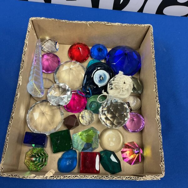 Collection of colourful vintage glass prisms and paperweights.