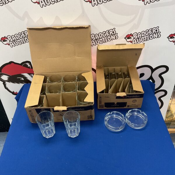 Box of glass tumblers and ashtrays, vintage barware collection.