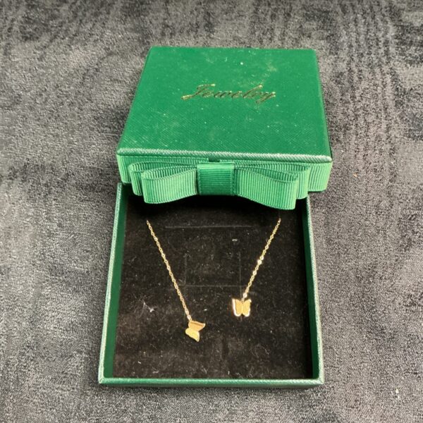 Gold plated butterfly drop stud earrings in a presentation box.