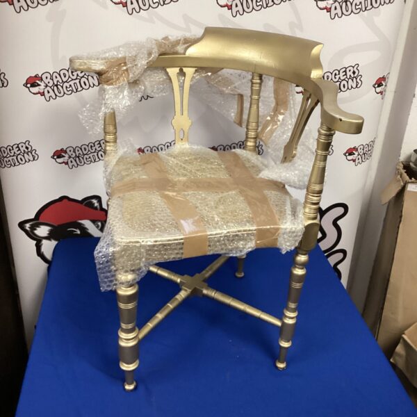Gold corner chair with sculpted back and cabriole legs.