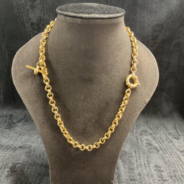 Vintage 9 carat gold plated T bar necklace on a neutral background.