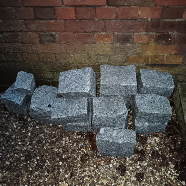 Lot of grey granite setts for garden paving.