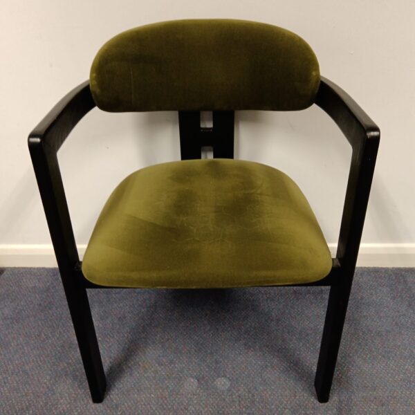 Green velvet chair with art deco styling.