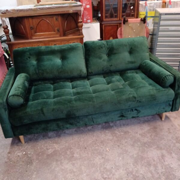 Green velvet Optisofa two-seater sofa in a home setting.