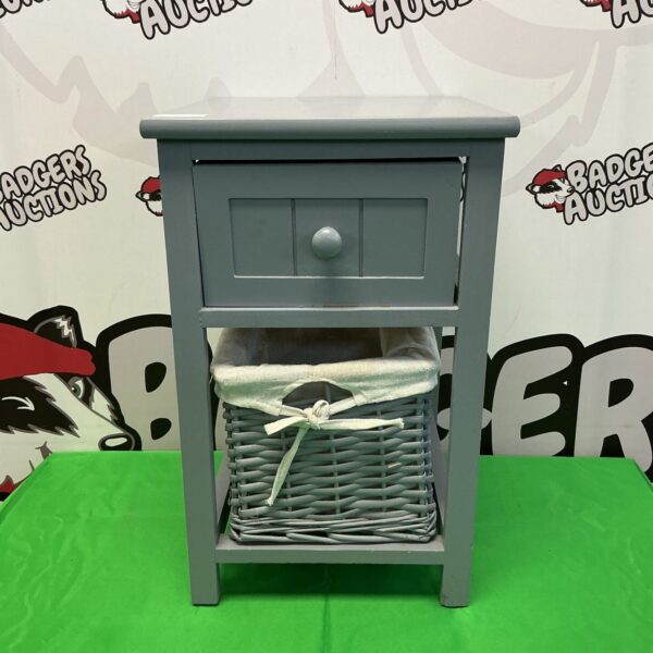 Grey shabby chic bathroom unit with wicker shelf.