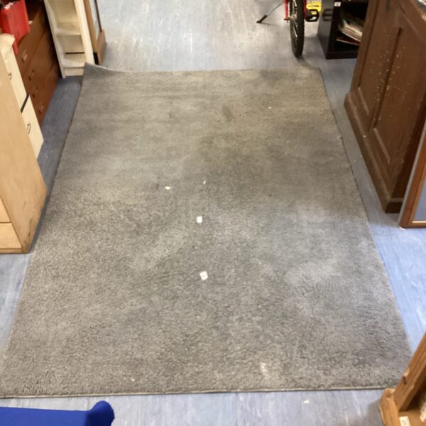 Large grey shag pile rug for living room floor.