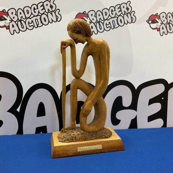 Hand carved wooden sculpture titled "Hope Along" depicting a man.