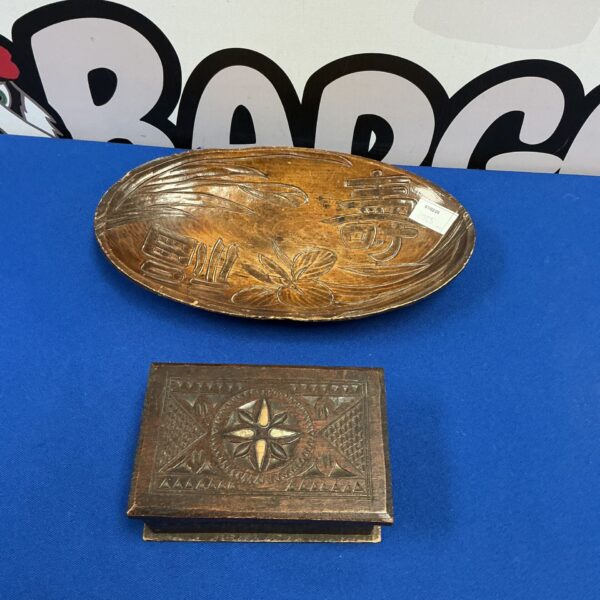 Intricately carved wooden trinket box with floral design.