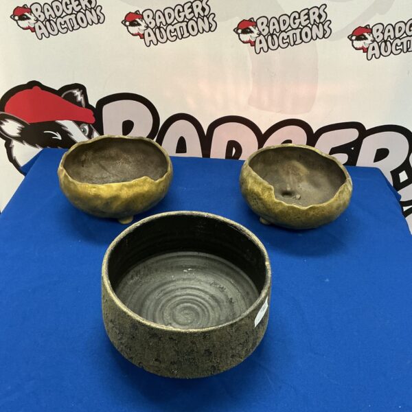 Lot of three handmade ceramic bowls with rustic finish.