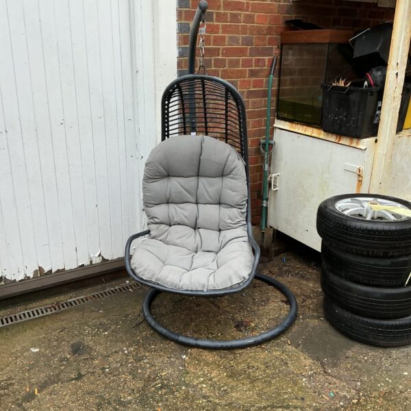 Woven hanging garden chair in an outdoor setting.