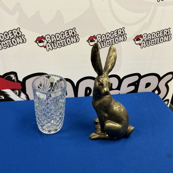 Detailed hare figurine with crystal vase for home decor.