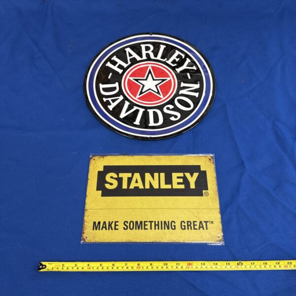 Vintage Harley Davidson and Stanley tin advertising signs.