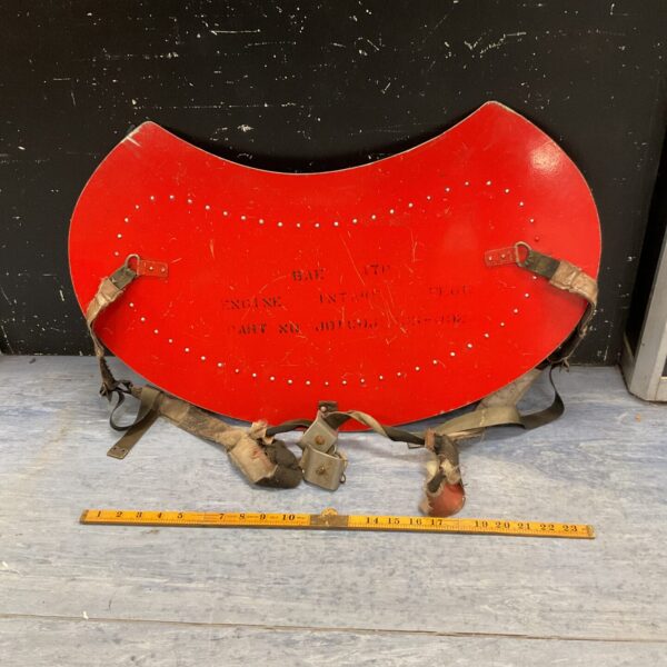 Red vintage Harrier engine intake cover with straps.