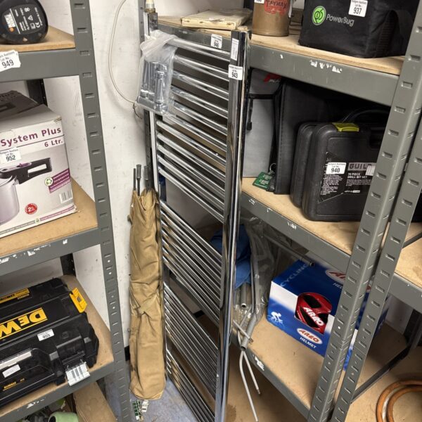 Chrome heated towel rail for bathroom use.