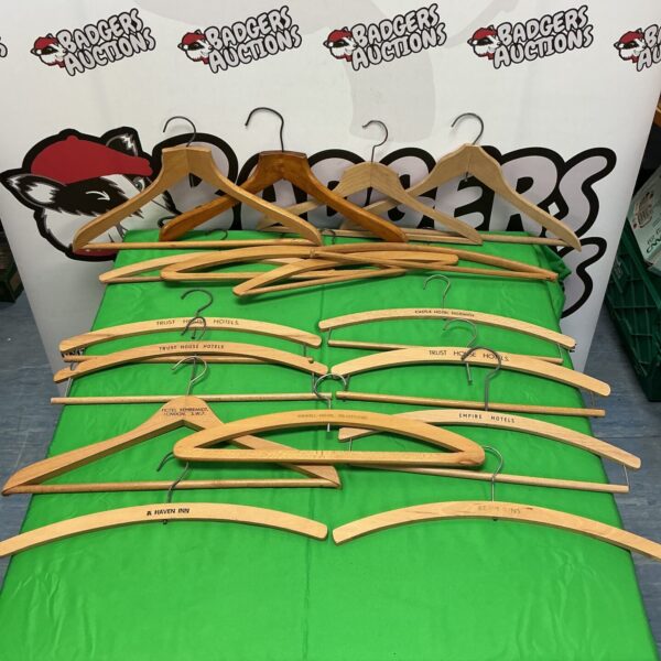 Vintage wooden hotel coat hangers from Rembrandt and Trust House hotels.