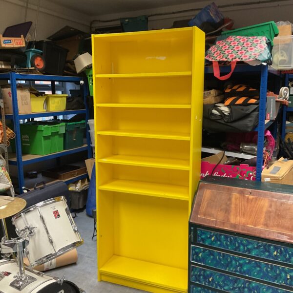 Yellow Ikea Billie bookcase for compact storage.