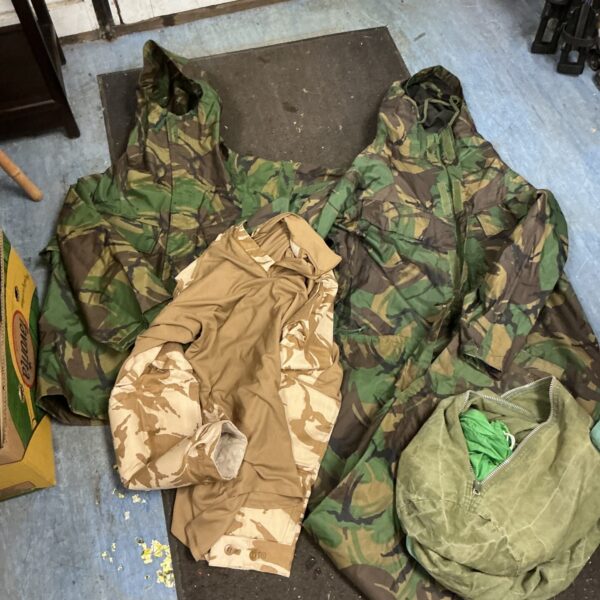 Army duffle bag with mixed camo waterproof and desert shirt clothing contents