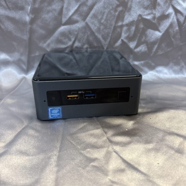 Black Intel NUC mini PC, model BOXNUC7CJYSAMN, compact desktop computer.