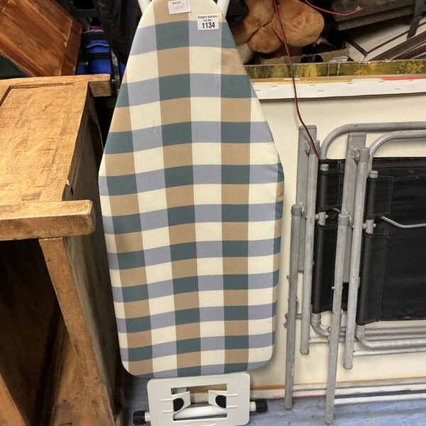 Used folding ironing board for pressing clothes and linens.