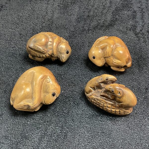 Antique Japanese netsuke collection featuring a carved animal figure.